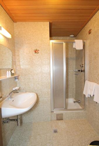 a bathroom with a sink and a shower at Pension Mittagskogel in Sankt Leonhard im Pitztal