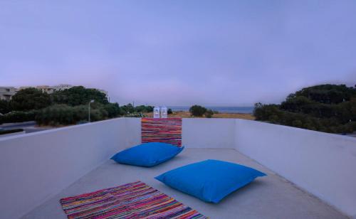 two blue pillows sitting on top of a balcony at Villa Elpiniki in Ixia