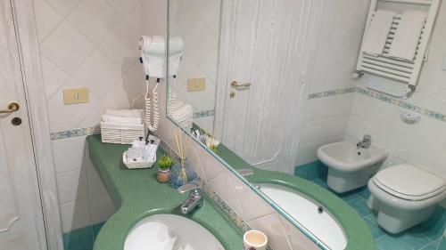 a bathroom with a sink and a toilet at Villa Bina Sea Hotel in Ischia