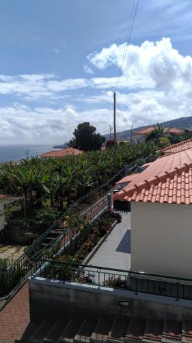 a balcony of a building with stairs and plants at Villas Madalena Chalets vista mar cWiFi in Santa Cruz