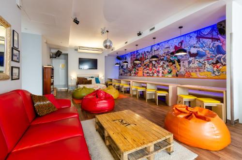 a living room with a red couch and a table at Yes Lisbon Hostel in Lisbon