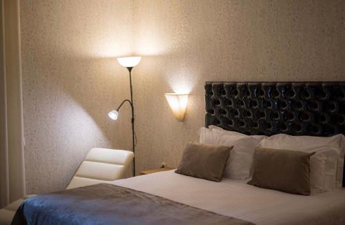 a bedroom with a bed with two pillows and a lamp at Paraiso Douro in Lamego