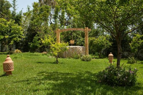 a garden with a fountain in the middle of the grass at Dar Tanja Boutique Hotel in Tangier