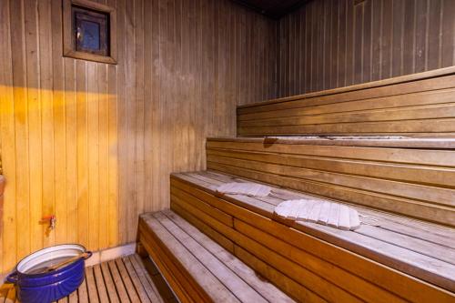 an empty wooden sauna with a bucket in it at Laguna in Slavske