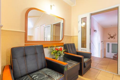 a waiting room with two chairs and a mirror at Laguna in Slavske