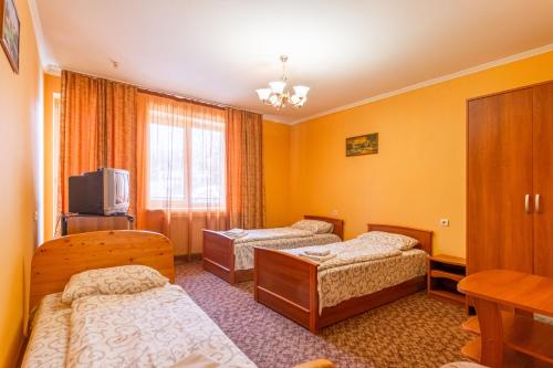 a hotel room with two beds and a television at Laguna in Slavske