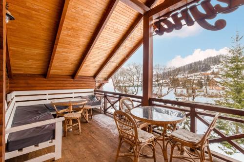 a balcony with a table and chairs and a view at Laguna in Slavske