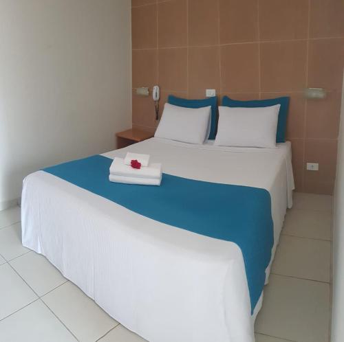 a bedroom with two beds with blue and white at Pousada Maragolfinho in Maragogi