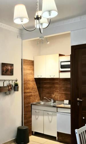 a kitchen with white cabinets and a sink at Soggiorno dell Agnolo in Florence