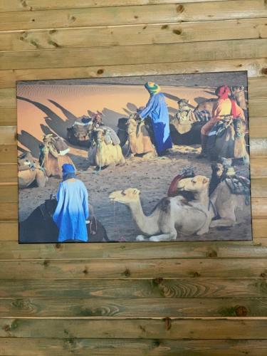 a painting on a wall with people and animals at Rakši in Cēsis