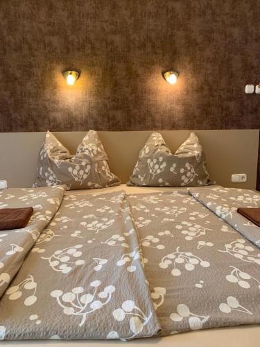 a bedroom with two beds with pillows at Balaton Apartmanház in Siófok