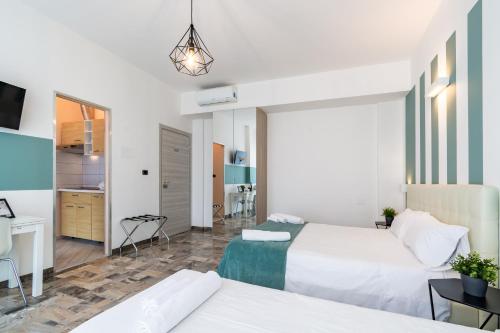 a hotel room with two beds and a desk at 4 Star Bologna Train Station - Self Check-In in Bologna