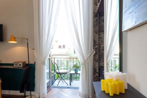 a room with white curtains and a table with yellow candles at Accademia 39 in Sorrento