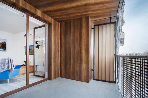 a room with a wooden door and a mirror at PIANISSIMO in Krakow