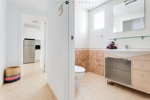 a bathroom with a toilet and a sink at Amiga in Alicante