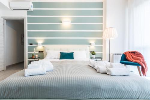 a blue and white bedroom with a large bed at 4 Star Bologna Train Station - Self Check-In in Bologna