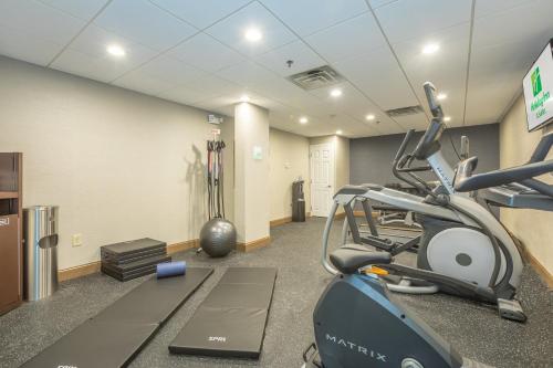 a gym with a treadmill and a exercise bike at Holiday Inn Hotel and Suites Peachtree City by IHG in Peachtree City