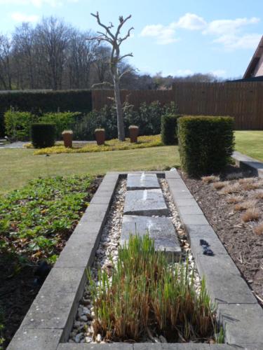 a garden with a stone walkway in a yard at Bosrand81 in Hechtel