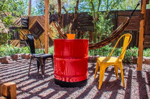 a group of chairs and a red barrel at San Pedro Domos in San Pedro de Atacama