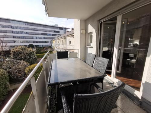 a table and chairs on a balcony with a building at Traumreise mit Balkon zentral in Friedrichshafen