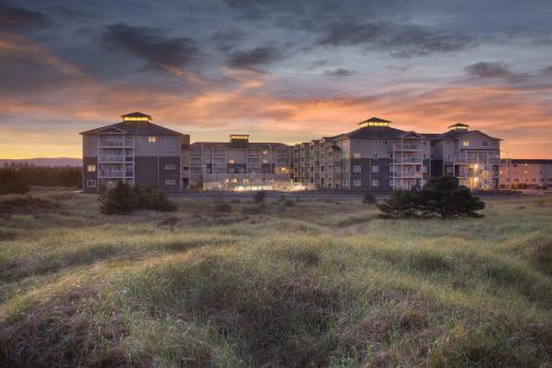 a large apartment building in a field at sunset at WorldMark Long Beach in Long Beach
