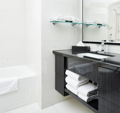 a bathroom with a sink and a mirror at Granville Island Hotel in Vancouver