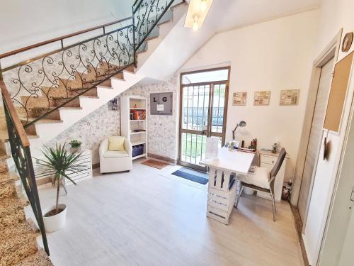 an open living room with a staircase and a desk at Le Giare B&B in Levanto