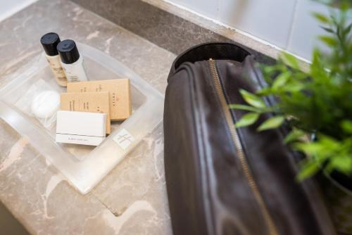 a suitcase sitting on a counter next to a box at Holiday Inn Manchester West by IHG in Manchester
