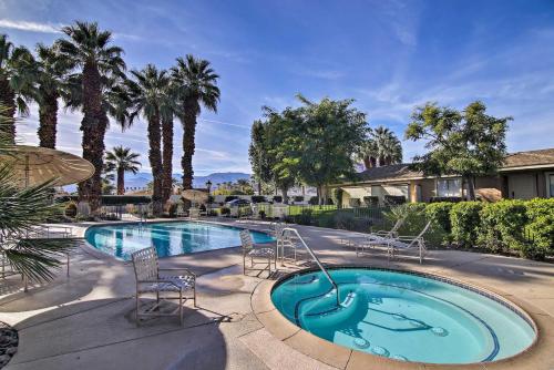 a swimming pool with chairs in a yard at Palm Desert Escape with Patio, Grill and Fire Pit in Palm Desert