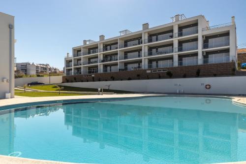 a large swimming pool in front of a building at NazOndas Ap in Nazaré