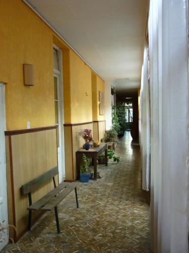 a hallway with a bench and a table in a building at Hotel Mallorca in Mendoza