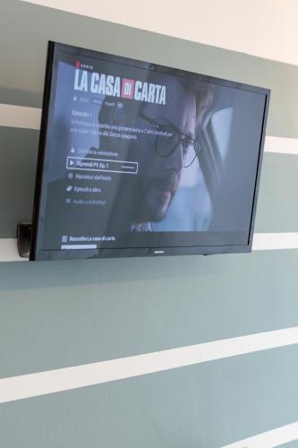 a flat screen tv sitting on top of a wall at 4 Star Bologna Train Station - Self Check-In in Bologna
