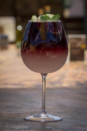 a glass of wine sitting on a table at Xaroma in Valle de Guadalupe