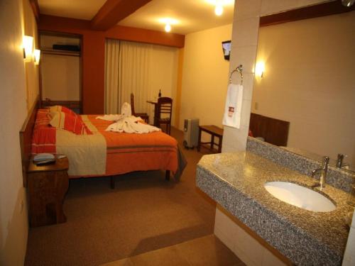Cama o camas de una habitación en Hotel Munay Tambo