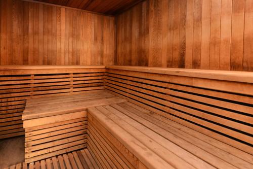 an empty wooden sauna with wooden benches in it at Holiday Inn Rancho Cordova - Northeast Sacramento by IHG in Rancho Cordova