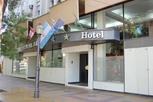 a hotel building with a street light in front of it at Hotel Puerta del Sol in Mendoza