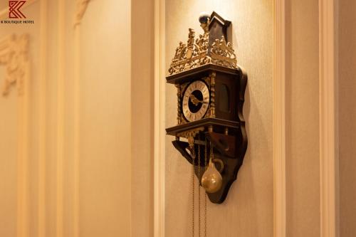 a clock on the wall with a crown on it at TTR Skypool View Hotel in Da Lat