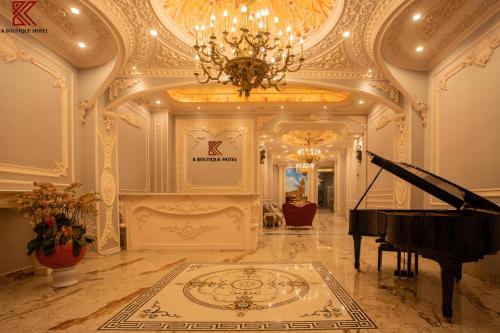a large room with a piano and a chandelier at TTR Skypool View Hotel in Da Lat