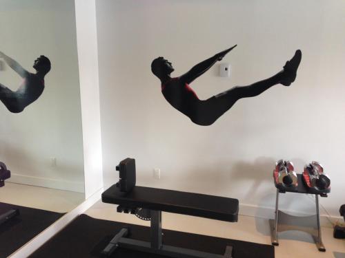 a room with a man doing a flip on the wall at Hotel V in Gatineau