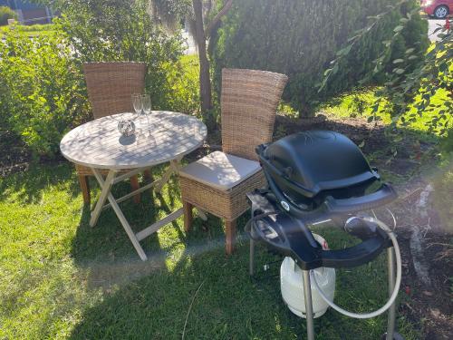 a table and chairs with a helmet on a motor bike at Stella Maris in Eden