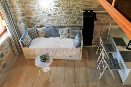 a living room with a couch and a table at Traditional Stone House at Great Location in Koroni