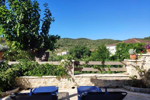 a group of blue chairs sitting in a yard at Traditional Stone House at Great Location in Koroni