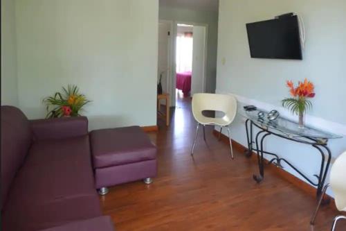 a living room with a couch and a glass table at Caribbean Villages Aparments in Bocas del Toro