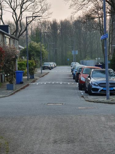 a parking lot with cars parked on the side of a street at Single family home in Hillegersberg - Schiebroek in Rotterdam