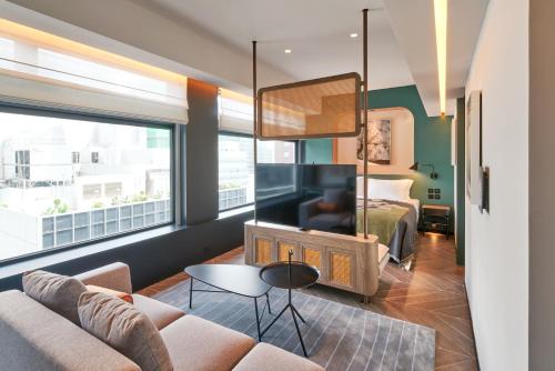a living room with a couch and a tv and a bed at the Arca in Hong Kong
