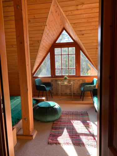 a room with a large window in a cabin at Rakši in Cēsis