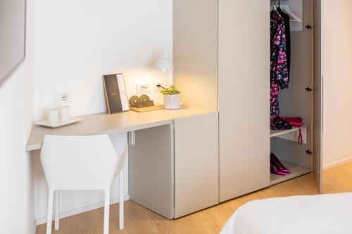 a room with a desk and a closet at Hotel Lago Di Garda in Nago-Torbole