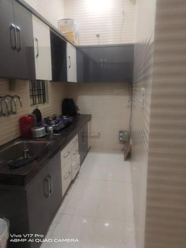 a kitchen with a sink and a counter top at Jasneet Homestay in Amritsar