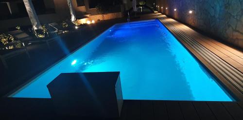 a large swimming pool with blue lighting in a building at Villa Ivan in Sveti Filip i Jakov