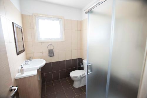 a bathroom with a toilet and a sink and a shower at Glabur Stays - The Sunny Atelier - Nicosia City, Free Parking & Wifi, Welcomes You!!! in Nicosia
